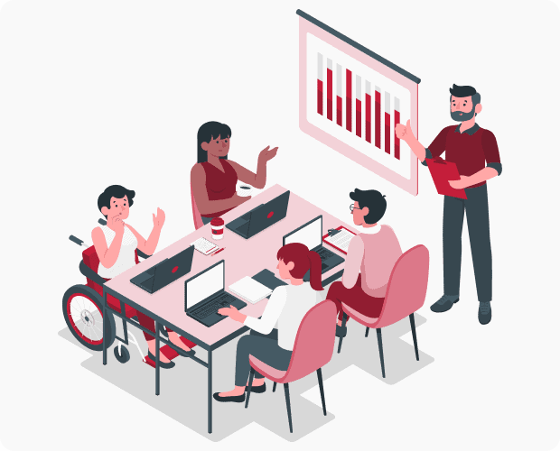 A meeting of people with disabilities. A facilitator stands beside a white board while participants with laptops sit at a table taking notes and brainstorming.